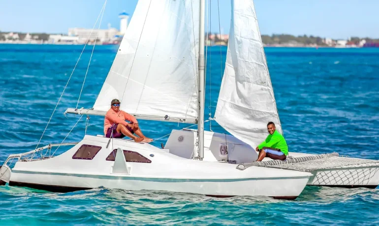 2 people smiling while sailing seawind catamaran