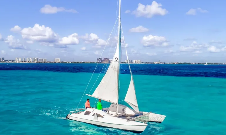 side view of two people sailing the 24ft catamaran