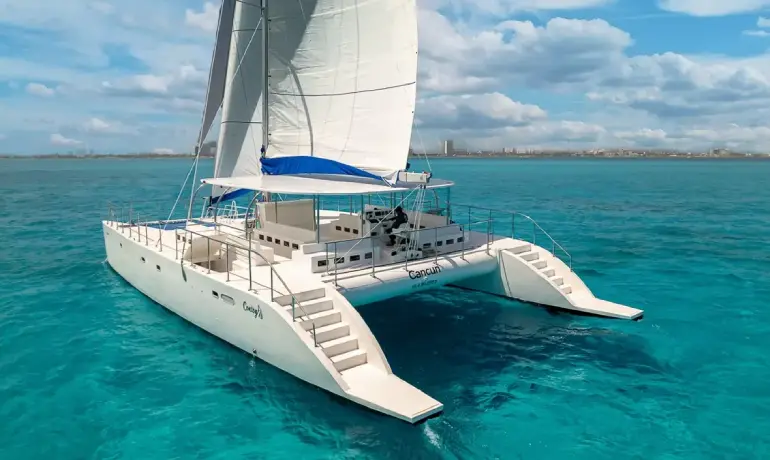 Back view of catamaran with cancun over the horizon