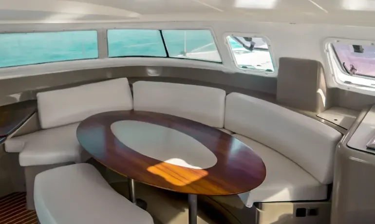 seats and wooden table inside marmajua catamaran