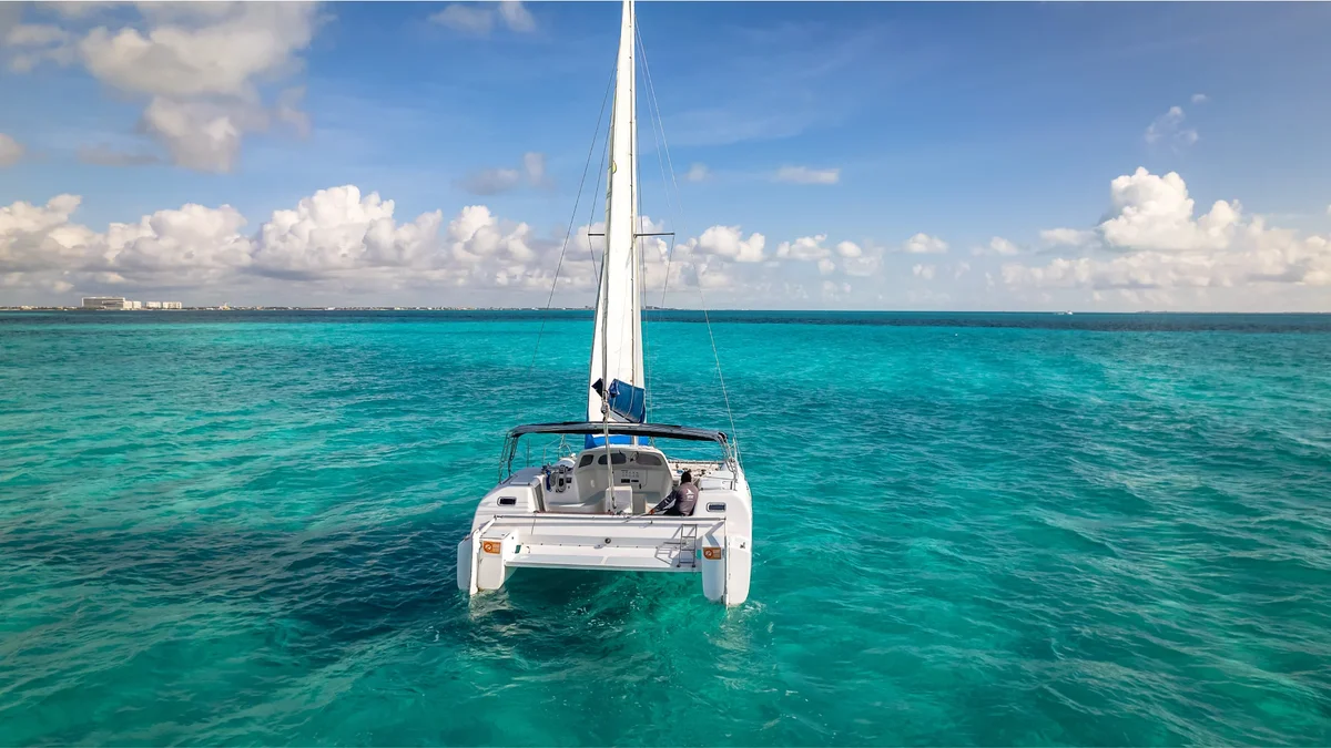 bow view of nal gone catamaran sailing in the blue sea